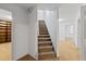 Carpeted staircase leading to the upper level, adjacent to a room with built-in wooden shelves at 350 Covered Bridge Sw Pl, Smyrna, GA 30082