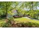An expansive yard with a two-car garage and beautiful flowering bushes at 350 Covered Bridge Sw Pl, Smyrna, GA 30082
