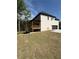 Expansive backyard with lush green grass and a charming deck, attached to an immaculate brick home at 409 Saint Surrey Way, Ellenwood, GA 30294