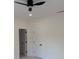 Simple bedroom with white walls, white trim, two doors, and a ceiling fan at 409 Saint Surrey Way, Ellenwood, GA 30294