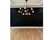 Modern dining room features a black accent wall and unique chandelier at 409 Saint Surrey Way, Ellenwood, GA 30294