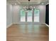 Bright dining area with modern chandelier, tray ceiling, and black accent wall at 409 Saint Surrey Way, Ellenwood, GA 30294