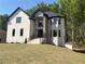 Stunning two-story home with stone accents, black trim, and professionally landscaped yard at 409 Saint Surrey Way, Ellenwood, GA 30294