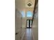Grand foyer with soaring ceilings, modern chandelier, and hardwood floors at 409 Saint Surrey Way, Ellenwood, GA 30294