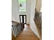 Front entry stairs with hardwood floors and a black metal railing at 409 Saint Surrey Way, Ellenwood, GA 30294