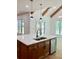 Kitchen island features a stainless steel sink, dishwasher, wood cabinets, and a white countertop at 409 Saint Surrey Way, Ellenwood, GA 30294