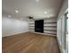 Spacious living room with hardwood floors, fireplace and floating shelves at 409 Saint Surrey Way, Ellenwood, GA 30294