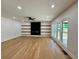 Spacious living room with hardwood floors, fireplace and floating shelves at 409 Saint Surrey Way, Ellenwood, GA 30294