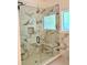 Glass shower with marbled tile and a built-in bench at 409 Saint Surrey Way, Ellenwood, GA 30294