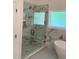 Luxurious bathroom featuring a glass enclosed shower with elegant marble tiling and a built-in bench at 409 Saint Surrey Way, Ellenwood, GA 30294