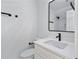 Modern bathroom featuring sleek black fixtures, white cabinetry, and a stylish rectangular mirror at 4100 Devon Wood Ne Dr, Marietta, GA 30066