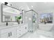 Spa-like primary bathroom with double sink vanity, soaking tub, and glass enclosed walk-in shower at 4100 Devon Wood Ne Dr, Marietta, GA 30066