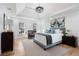 This light-filled main bedroom showcases a tray ceiling, neutral colors, hardwood floors and modern décor at 4100 Devon Wood Ne Dr, Marietta, GA 30066
