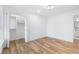 This bright bedroom features wood floors, white walls, trim, and a walk-in closet with double doors at 4100 Devon Wood Ne Dr, Marietta, GA 30066