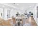 Elegant dining area with a glass table, comfortable chairs, and an open view into the living space at 4100 Devon Wood Ne Dr, Marietta, GA 30066