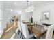 Dining room with a modern chandelier, wood table and views to the staircase and living room at 4100 Devon Wood Ne Dr, Marietta, GA 30066