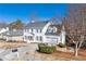 Lovely two-story home with a spacious driveway and beautiful landscaping on a sunny day at 4100 Devon Wood Ne Dr, Marietta, GA 30066