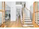 Bright foyer with hardwood floors, an elegant staircase, and views into the living spaces at 4100 Devon Wood Ne Dr, Marietta, GA 30066