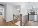 Bright hallway features wood floors, white trim, a chandelier, and a staircase with metal spindles at 4100 Devon Wood Ne Dr, Marietta, GA 30066