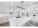 Spacious, well-lit kitchen with white cabinets, quartz countertops, and a central island with seating at 4100 Devon Wood Ne Dr, Marietta, GA 30066