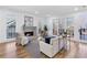 Bright living room featuring a stone fireplace, large windows, and comfortable seating arrangements at 4100 Devon Wood Ne Dr, Marietta, GA 30066
