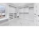 Spacious walk-in closet features custom shelving, drawers, and ample storage space, and a window at 4100 Devon Wood Ne Dr, Marietta, GA 30066