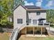 Backyard view with solar panels, deck, covered patio, and stairs leading up, eco-friendly and stylish at 829 Verdun Way, Marietta, GA 30064