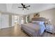 Primary bedroom features ceiling fan, tray ceilings, hardwood floors, natural light, and ensuite bathroom at 829 Verdun Way, Marietta, GA 30064