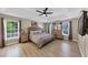 Primary bedroom featuring a tray ceiling, large windows, hardwood floors, and neutral decor at 829 Verdun Way, Marietta, GA 30064