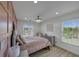Bright bedroom with pink accent wall, chandelier and lots of natural light at 829 Verdun Way, Marietta, GA 30064
