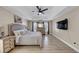 Primary bedroom featuring a ceiling fan, large windows, hardwood floors, a TV and neutral decor at 829 Verdun Way, Marietta, GA 30064