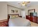 This bedroom has a ceiling fan, closet, and a wooden dresser with a big mirror that adds elegance at 829 Verdun Way, Marietta, GA 30064