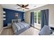 Bedroom features stylish blue accent wall, ceiling fan, and lots of natural light at 829 Verdun Way, Marietta, GA 30064