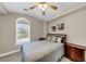 This bedroom features a beautiful arched window that provides natural light and a ceiling fan at 829 Verdun Way, Marietta, GA 30064