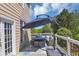 Outdoor deck with a seating area and umbrella, perfect for relaxing or entertaining at 829 Verdun Way, Marietta, GA 30064