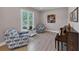 Charming den featuring hardwood floors, a piano and comfortable seating near a large window at 829 Verdun Way, Marietta, GA 30064