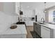 Modern kitchen featuring white cabinets, quartz countertops, stainless steel appliances, and stylish backsplash at 829 Verdun Way, Marietta, GA 30064