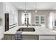 Kitchen island with seating, sink, and pendant lights, complemented by stainless steel appliances at 829 Verdun Way, Marietta, GA 30064