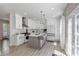 Modern kitchen featuring a large island, white cabinets, stainless steel appliances, and pendant lighting at 829 Verdun Way, Marietta, GA 30064