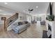 Spacious living room with fireplace, large TV, cozy seating areas, and open staircase at 829 Verdun Way, Marietta, GA 30064