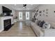 Bright living room featuring hardwood floors, fireplace, and comfortable seating. with a fan at 829 Verdun Way, Marietta, GA 30064