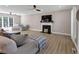 Bright living room featuring hardwood floors, fireplace, and comfortable seating, with a fan at 829 Verdun Way, Marietta, GA 30064