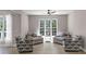 Bright sitting area featuring hardwood floors and comfortable seating near a large window at 829 Verdun Way, Marietta, GA 30064