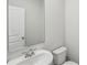 Half bathroom featuring a white sink, a toilet, a mirror and white walls at 1280 Firefly Field Trce, Lawrenceville, GA 30045