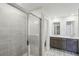 An elegant bathroom features a tiled shower and dual vanities, combining style and functionality at 1280 Firefly Field Trce, Lawrenceville, GA 30045