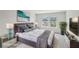 A stylish staged bedroom includes a modern bed, sleek furniture, and natural light from two windows at 1280 Firefly Field Trce, Lawrenceville, GA 30045
