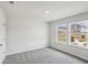 Bedroom with gray carpet, neutral walls, white trim and a window with natural light at 1280 Firefly Field Trce, Lawrenceville, GA 30045