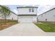 A modern two-story home features a white facade, a black roof, and a spacious driveway at 1280 Firefly Field Trce, Lawrenceville, GA 30045