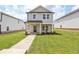 Charming two-story home with well-manicured lawn and inviting front porch and walkway at 1280 Firefly Field Trce, Lawrenceville, GA 30045