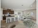 Staged open kitchen featuring stainless appliances, kitchen island and view to the living room at 1280 Firefly Field Trce, Lawrenceville, GA 30045
